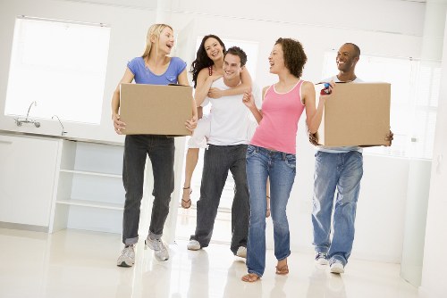 Man and Van Acton team handling boxes safely during a move