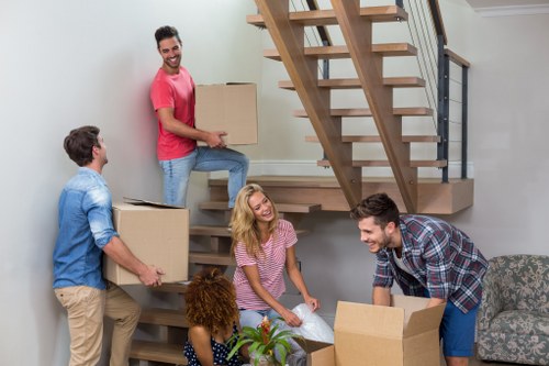 Professional packing team helping a customer prepare boxes for a move in Acton
