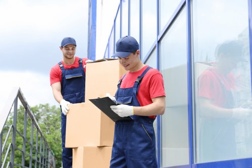 Loading furniture into a moving truck on an Acton street