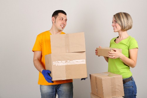 Business relocation process with boxes, desks, and setup at the new premises